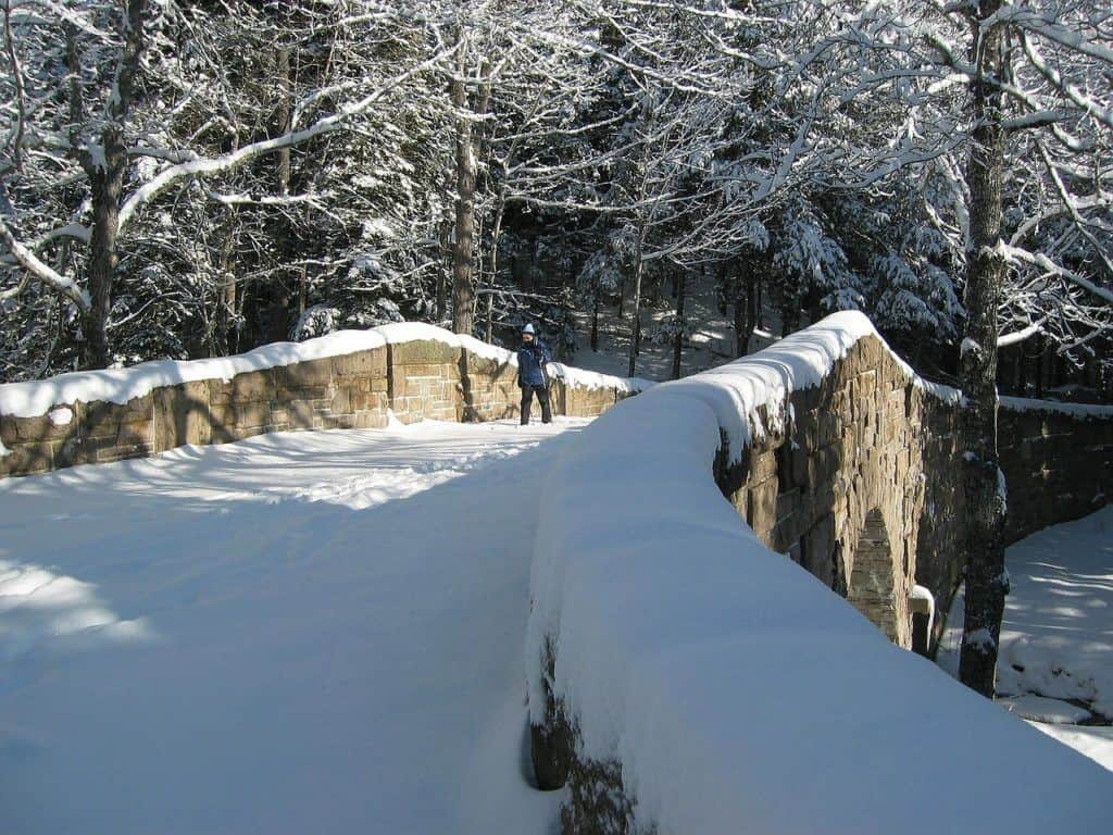 romantic national parks A person cross-country skiing on the carriage roads in Acadia National Park.