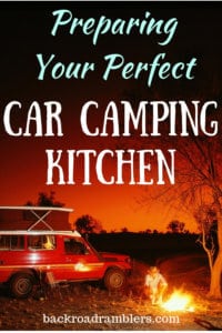 car camping kitchen A red jeep parked next to a campfire. Caption: Preparing Your Perfect Car Camping Kitchen