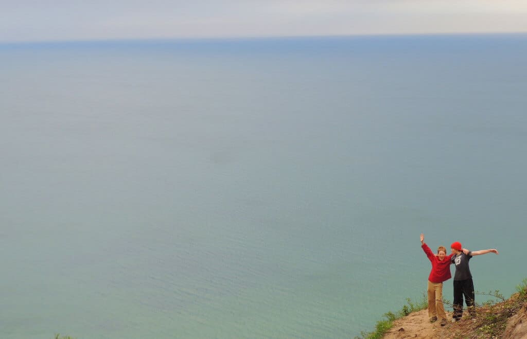 My kids as preteens on our very first cross-country trip together. They are standing on a bluff overlooking Lake Superior in Michigan.