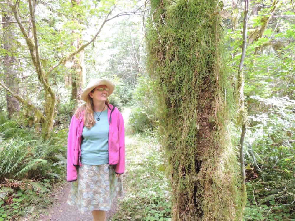A woman hikes along the Kestner Homestead Trail in the Quinault Rainforest in Olympic National Park. 