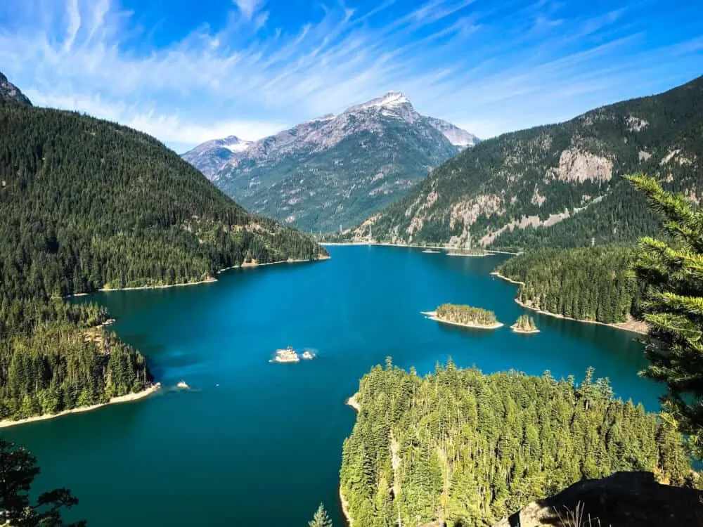 a view of a deep blue lake surrounding by mountains in North Cascades National Park
