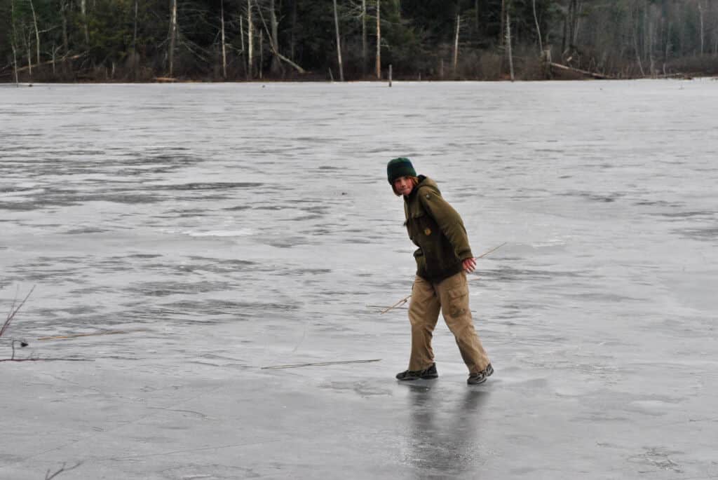 A boy playing on the ice at Woodford State Park.