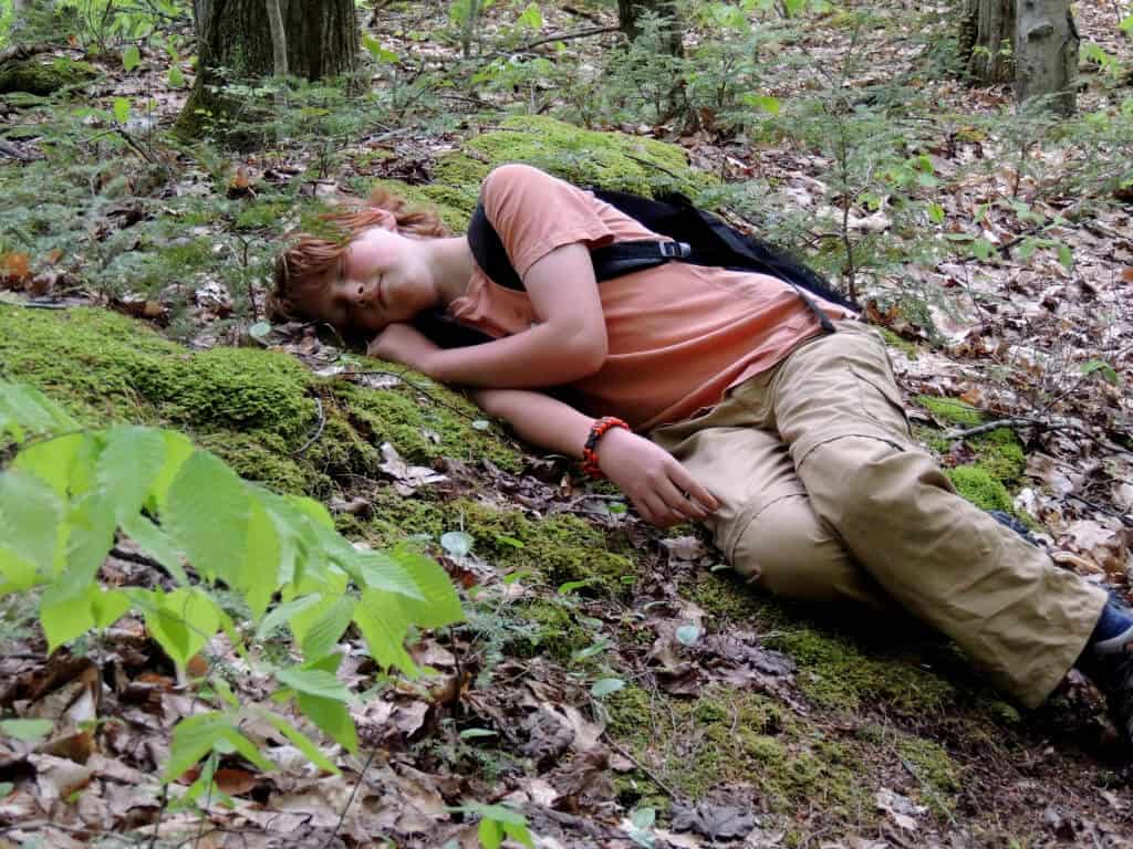 A child takes an afternoon nap in the woods of Vermont.