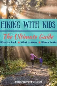 A woman walks through the woods with a young girl. Caption reads: Hiking with Kids: The Ultimate Guide