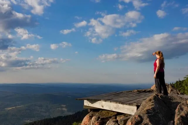 A hiker checks out the view from the hang gliding platform of the summit of Mt. Ascutney.