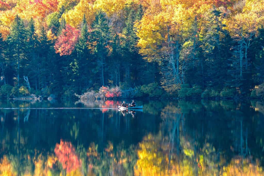 A fall foliage shot of Grout Pond in Vermont during October.
