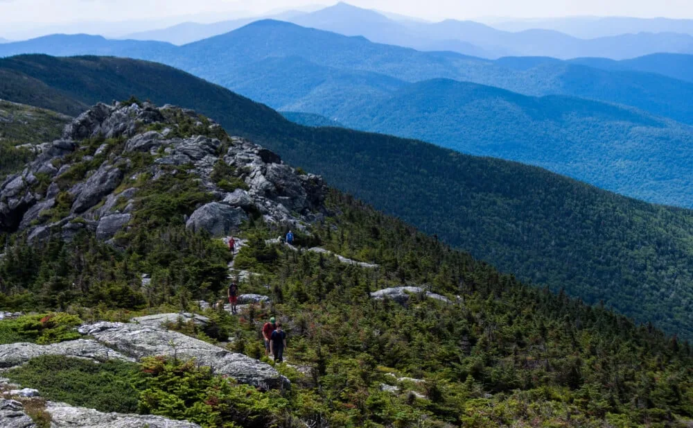 A group of hikers walks along the ridge of Mt. Mansfield in Stowe, Vermont.
