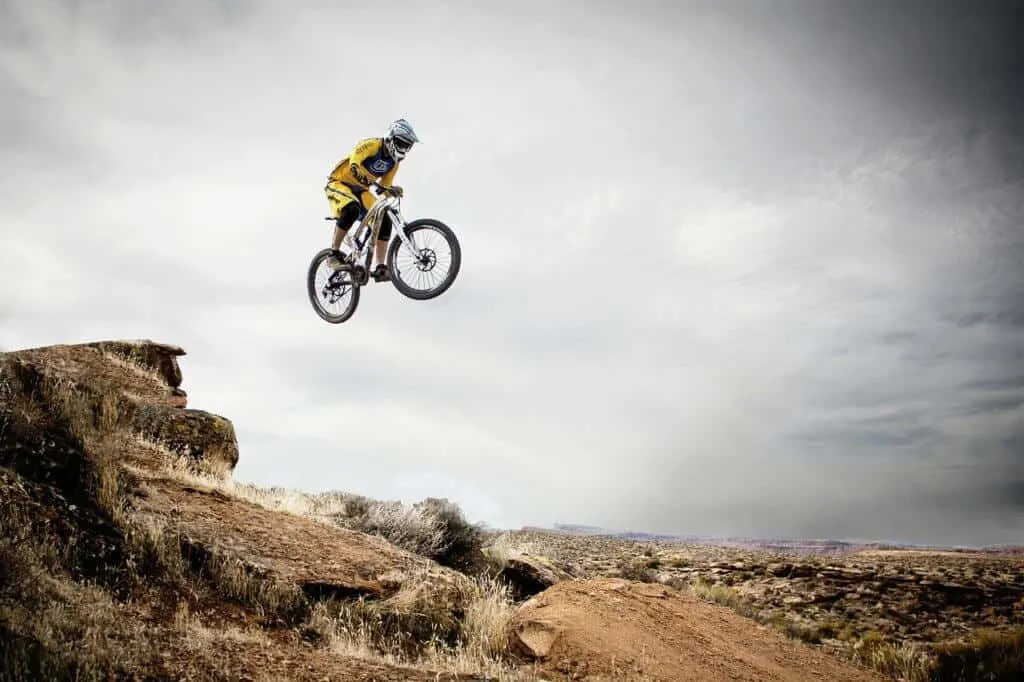 A mountain bike flies over a cliff on a mountain biking trail in Utah