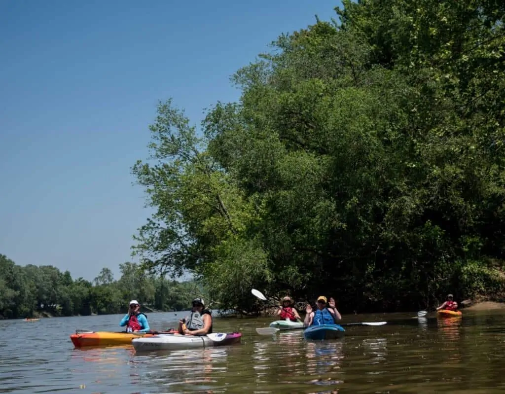 a group of kayakers paddling on the Ohio River in Marietta, Ohio