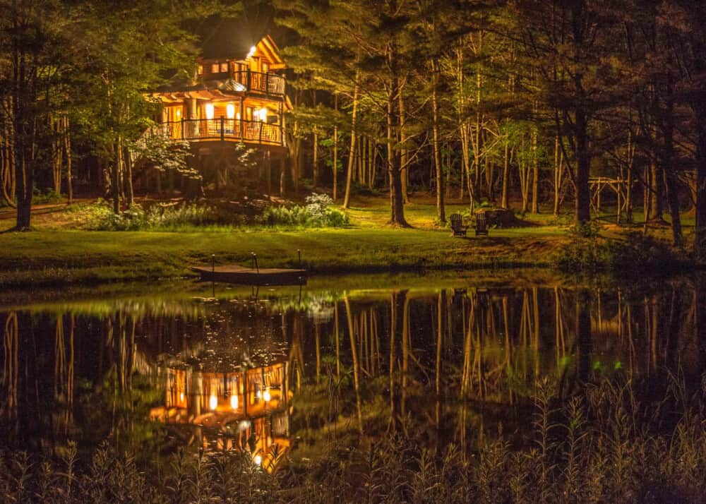 A nighttime view of the Vermont treehouse at Moose Meadow Lodge