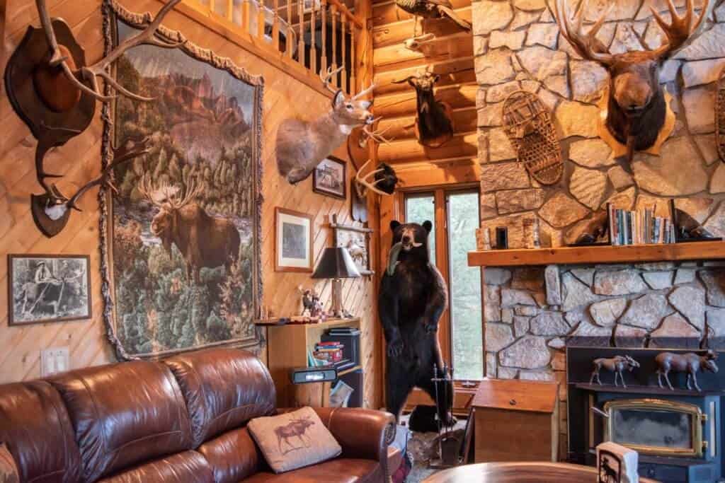 An Adirondack-style living room in Moose Meadow Lodge - complete with stuffed critters and snowshoes on the walls.