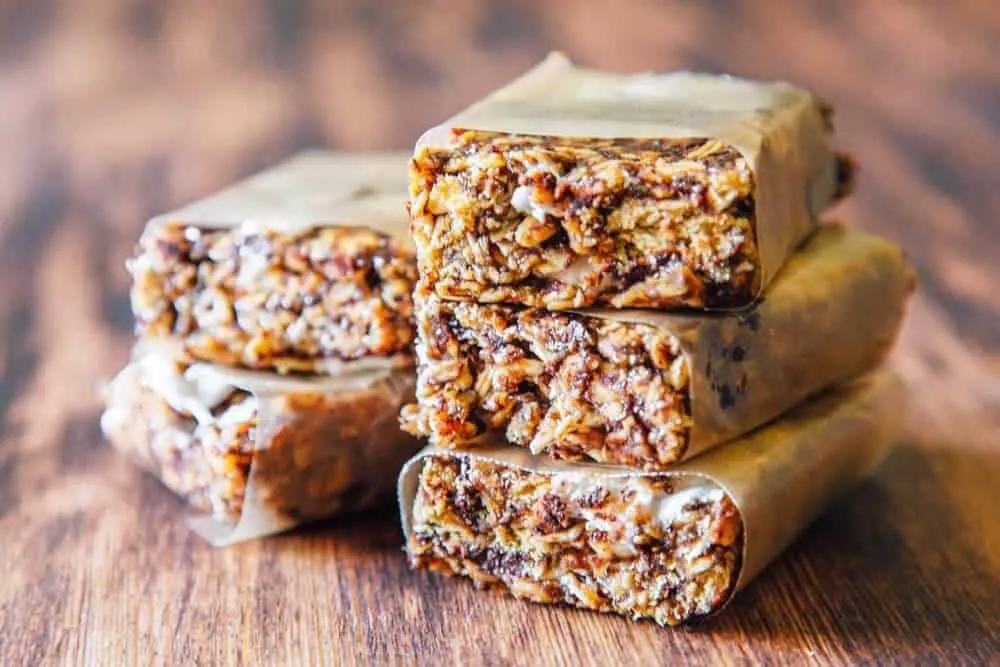 A stack of granola bars wrapped in parchment paper. Photo credit: Fresh Off the Grid.