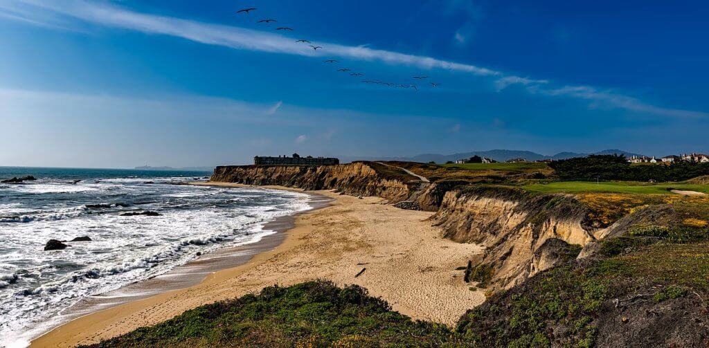 Best Beaches in the Bay Area A wide landscape view of Half Moon Bay in the Bay Area of California.