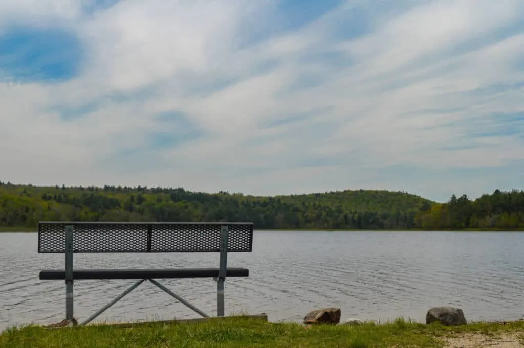A lone bench overlooking McDowell Dam in Peterborough, NH