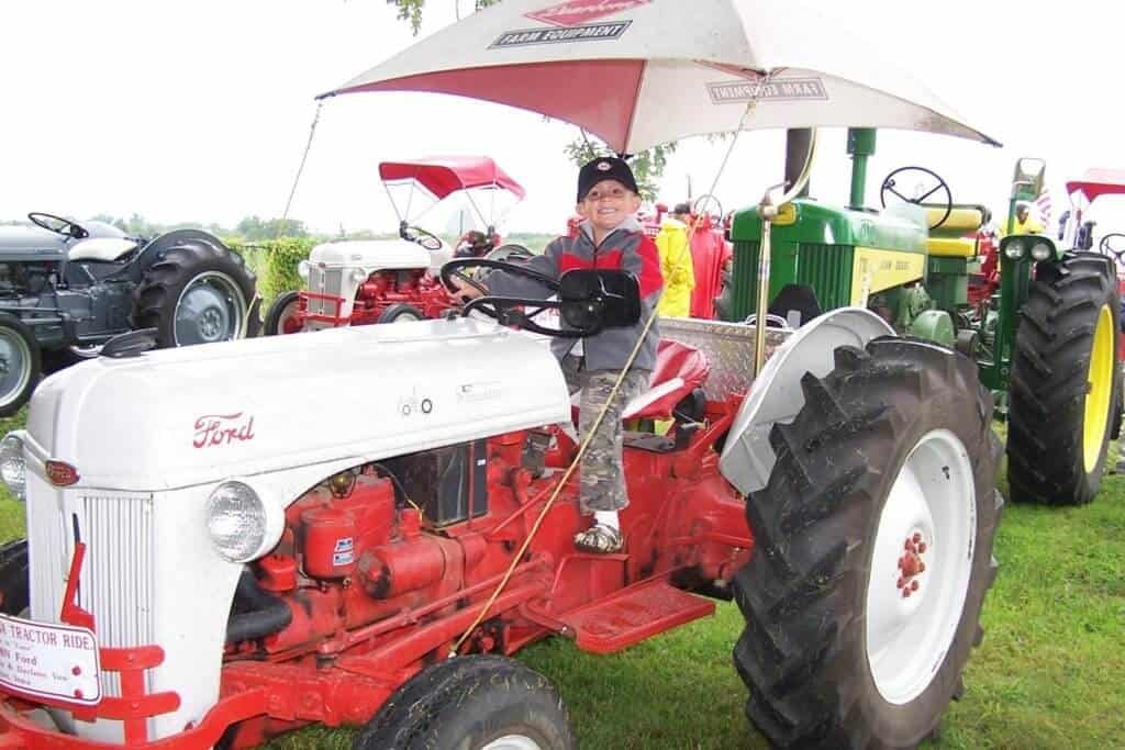 A small boy sits on a tractor in Kirksville, MO