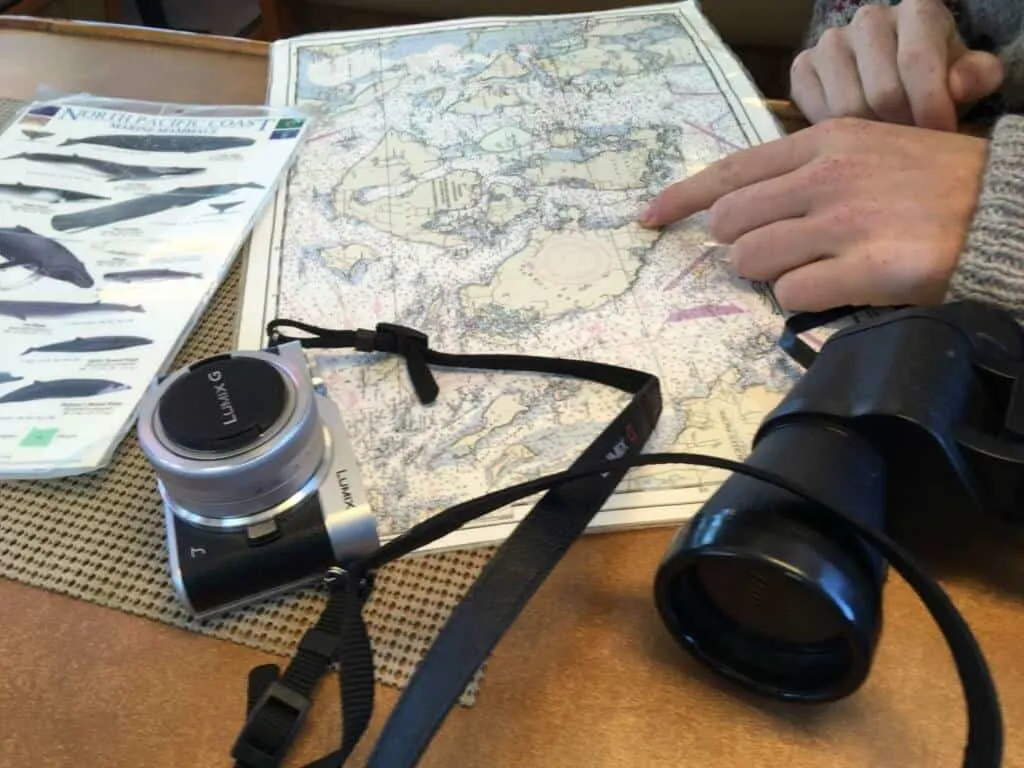 a map of the Puget Sound, binoculars, and a camera
