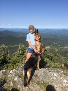A woman stands on top of a mountain in Vermont