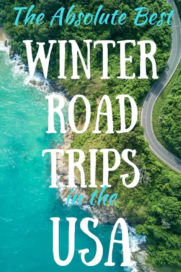 An aerial view of a road near the ocean. Caption reads: The Absolute Best Winter Road Trips in the USA.