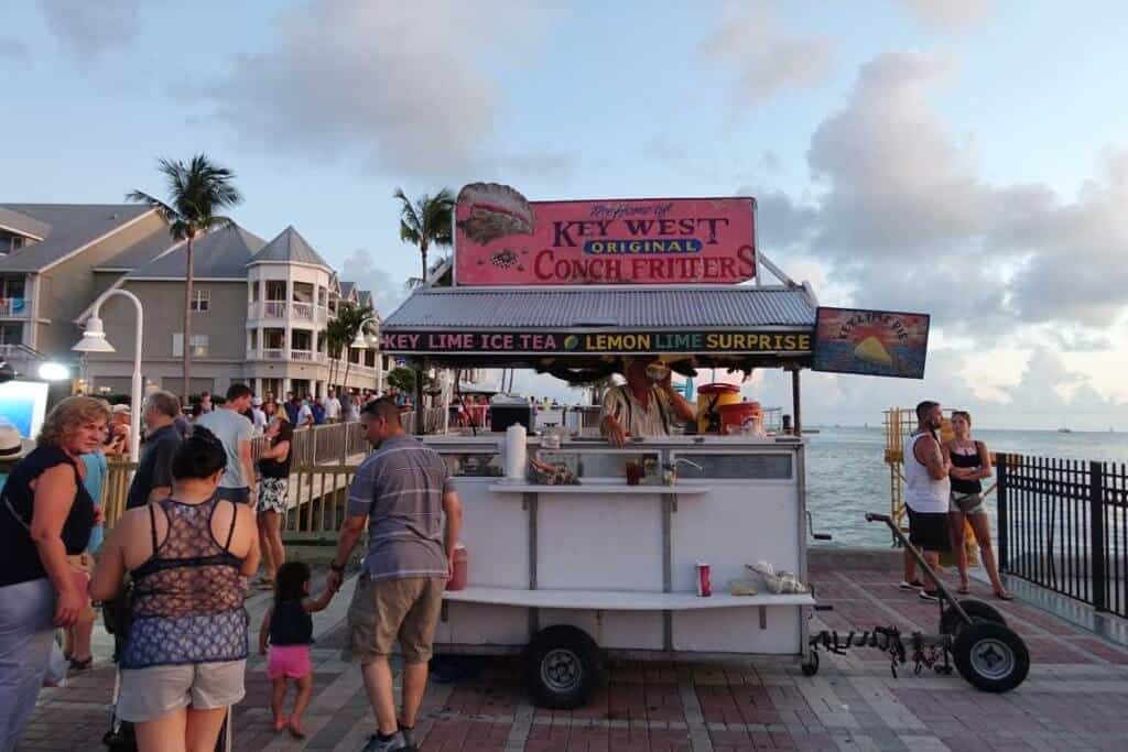 Several people wait at a food stand in Key West, Florida.