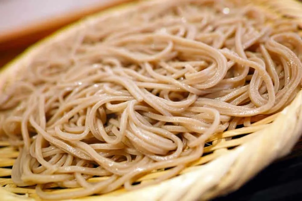 a close-up of peanut noodles with spicy peanut sauce.