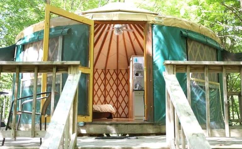 The front door and inside view of a New York yurt rental in East Meredith, NY