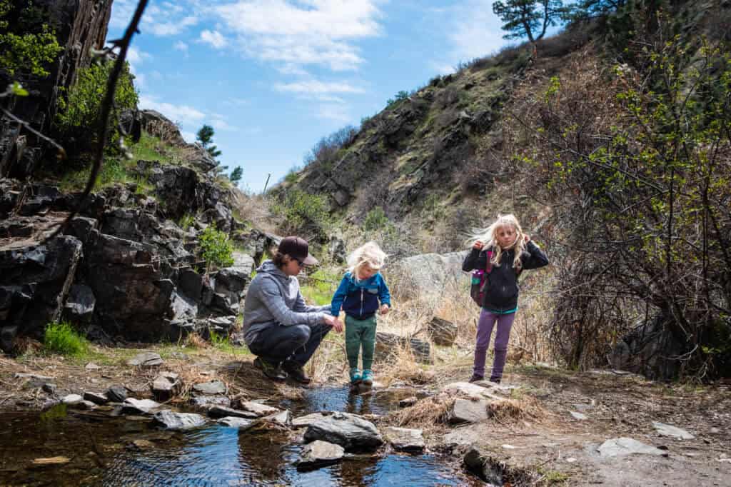 Some kids stop to rest while hiking at Lory State Park in Fort Collins, Colorado