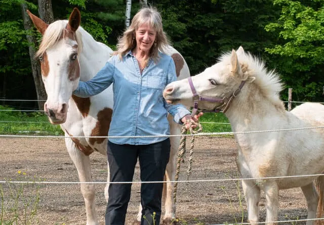 Ellen stands with horses, Maya and Nahvee
