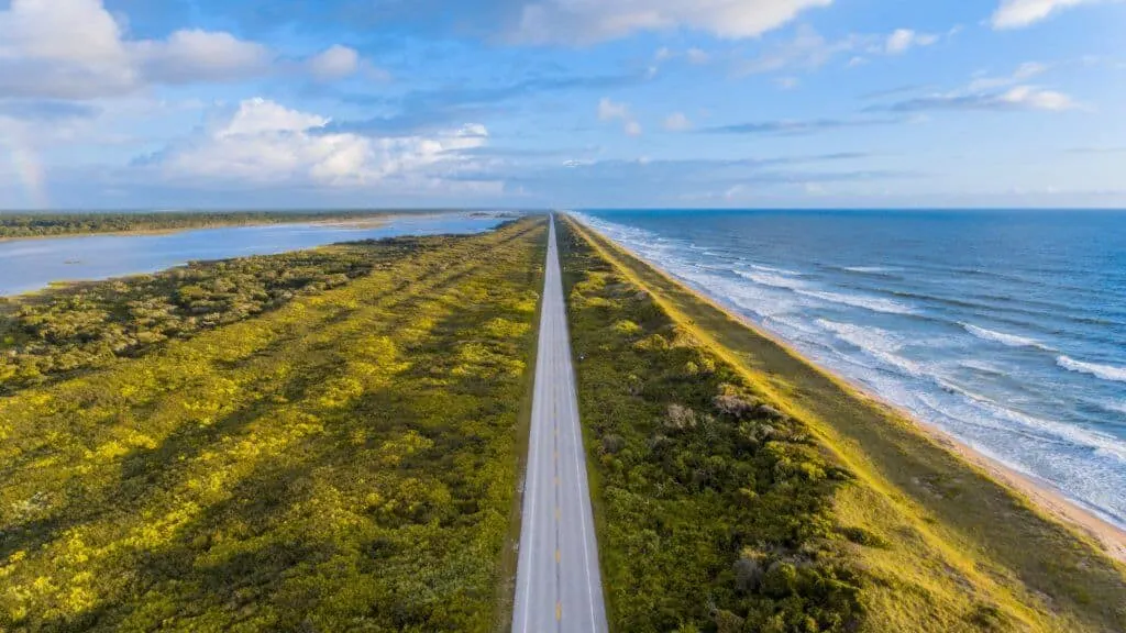 A long stretch of the highway next to the ocean.