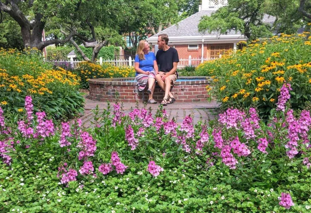 A couple sits near a fountain in Prescott Park in Portsmouth, one of the most romantic getaways in New Hampshire.