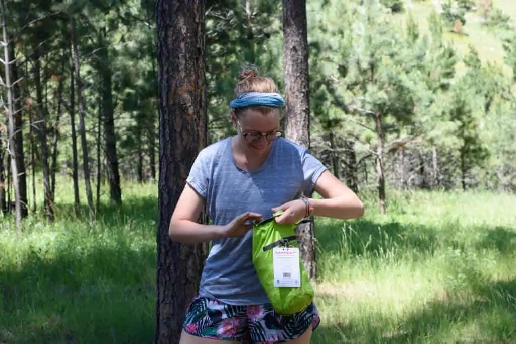 Abbey holding the Kammock Mantis hammock inside its stuff sack.