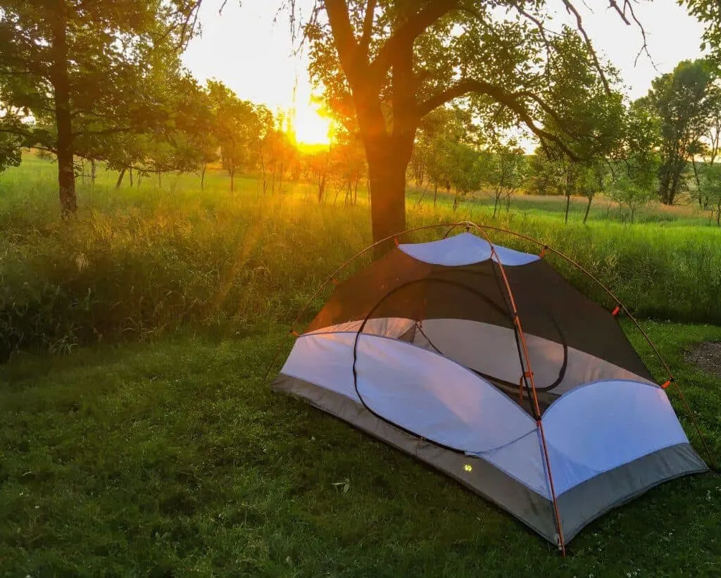 The sun sets over a small tent in Minnesota. 