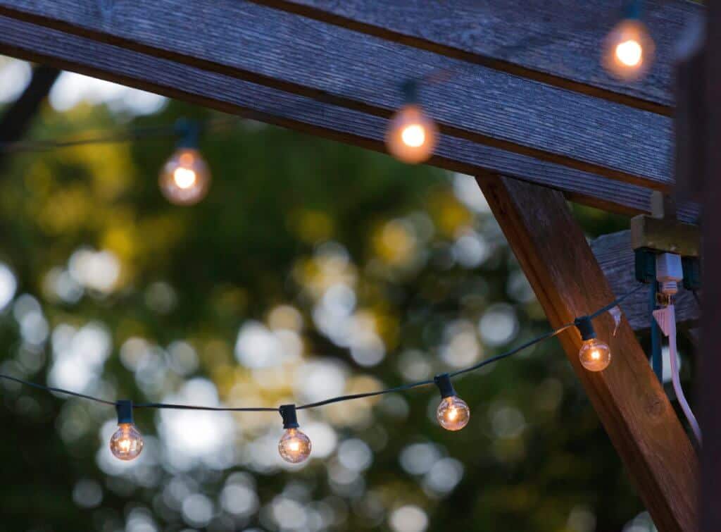 A string of lights hanging off the outside of a house - perfect for hygge living.