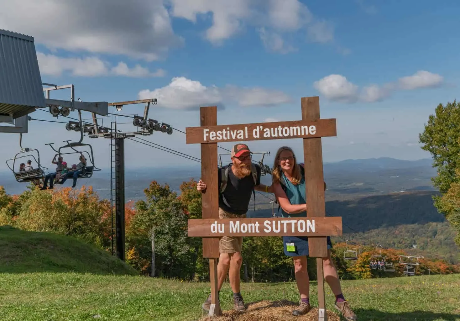 Eric and Tara Schatz standing on top of Sutton Mountain in Quebec.