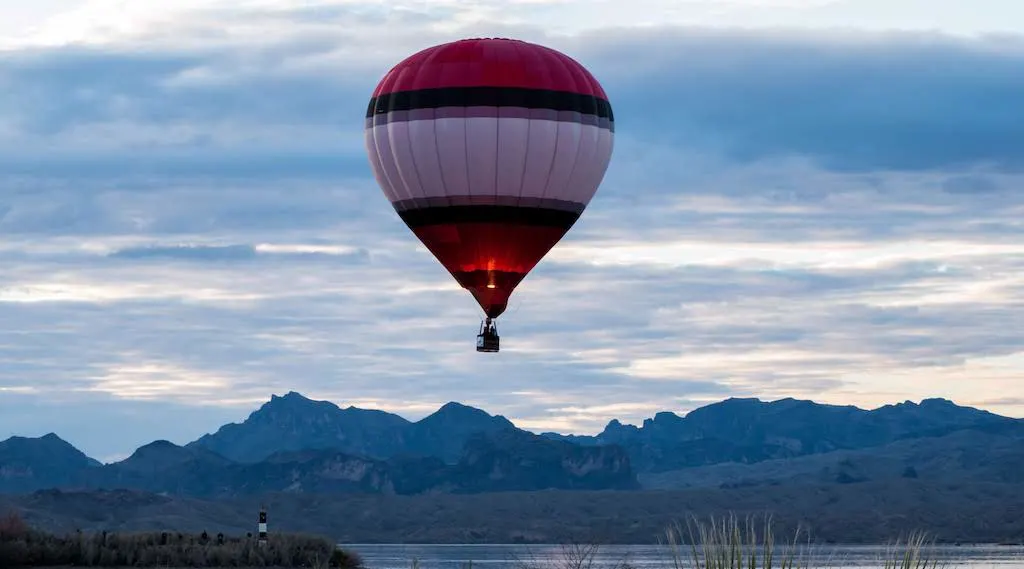 A single hot air balloon floats over the mountains in Lake Havasu City, AZ