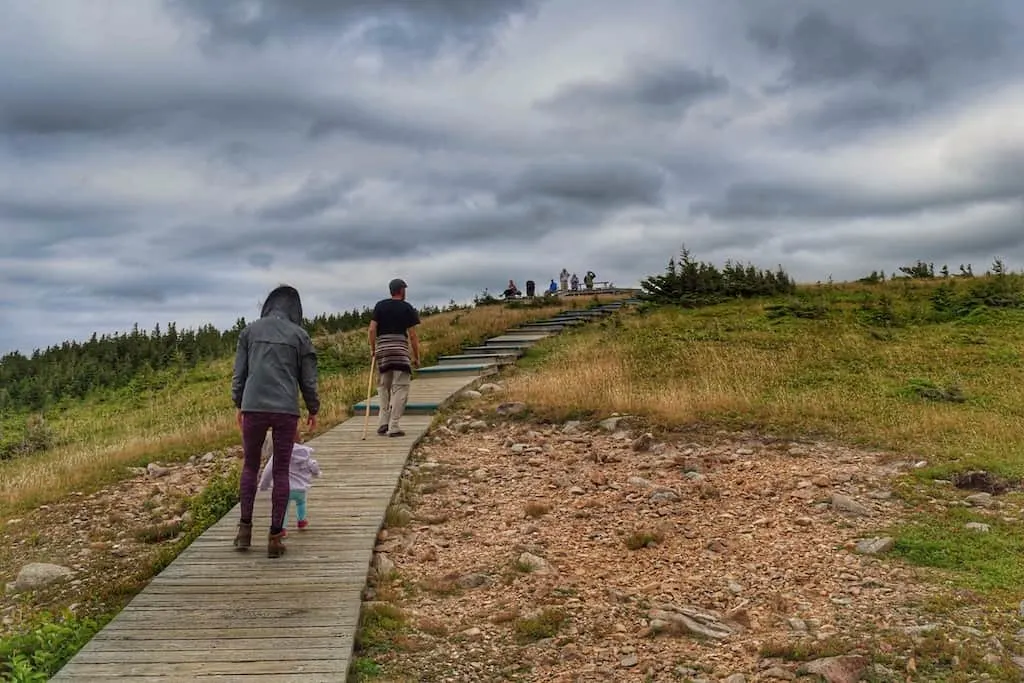 A few people walk on the boardwalk on Cape Breton Island