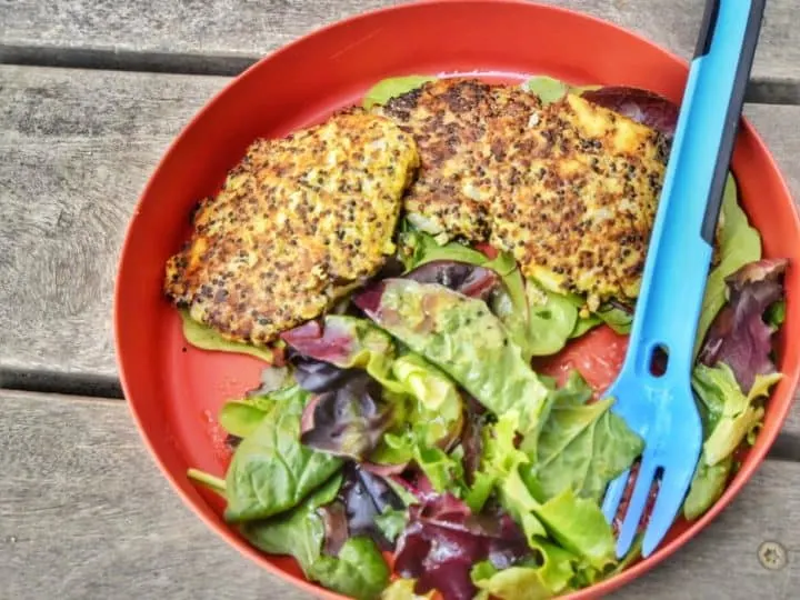 A camping plate with salad and quinoa patties