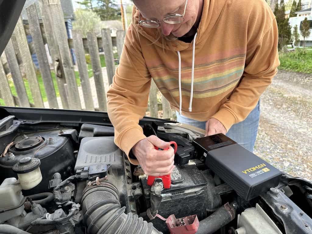 These are the Six Road Trip Essentials We Never Travel Without 3 Tara jumpstarting her car with the VTOMAN X7 Jump Starter with Air Compressor.