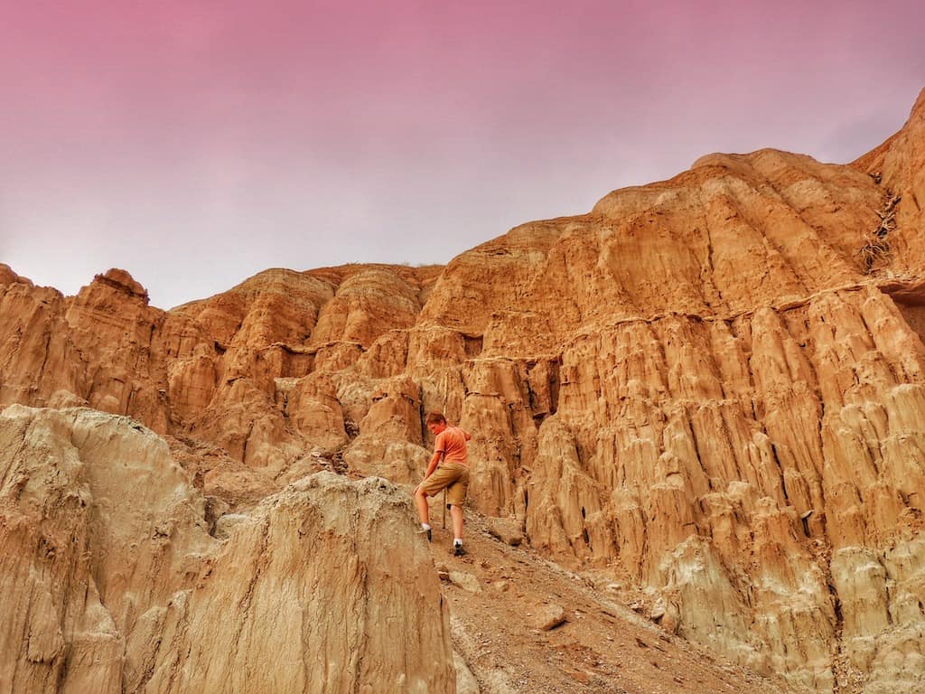A boy hikes among the red rocks at Cathedral Gorge State Park in Nevada.
