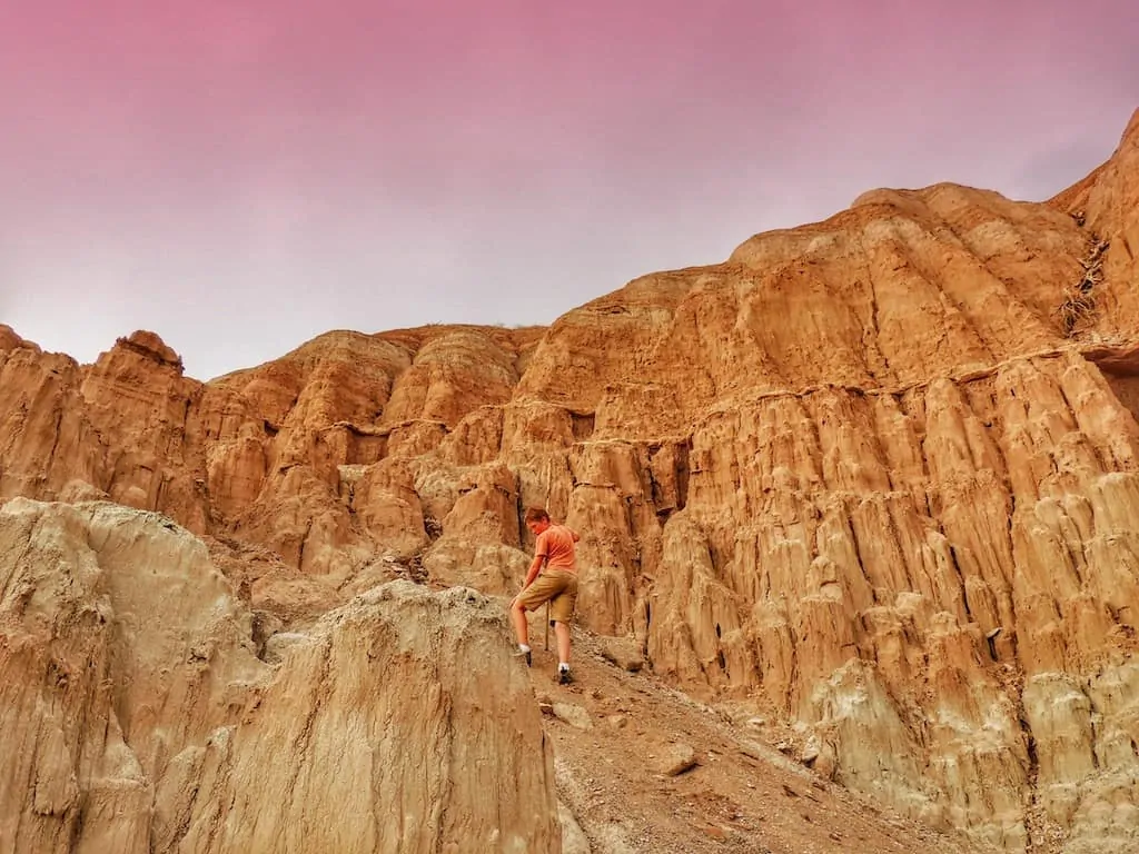 A boy hikes among the red rocks at Cathedral Gorge State Park in Nevada.