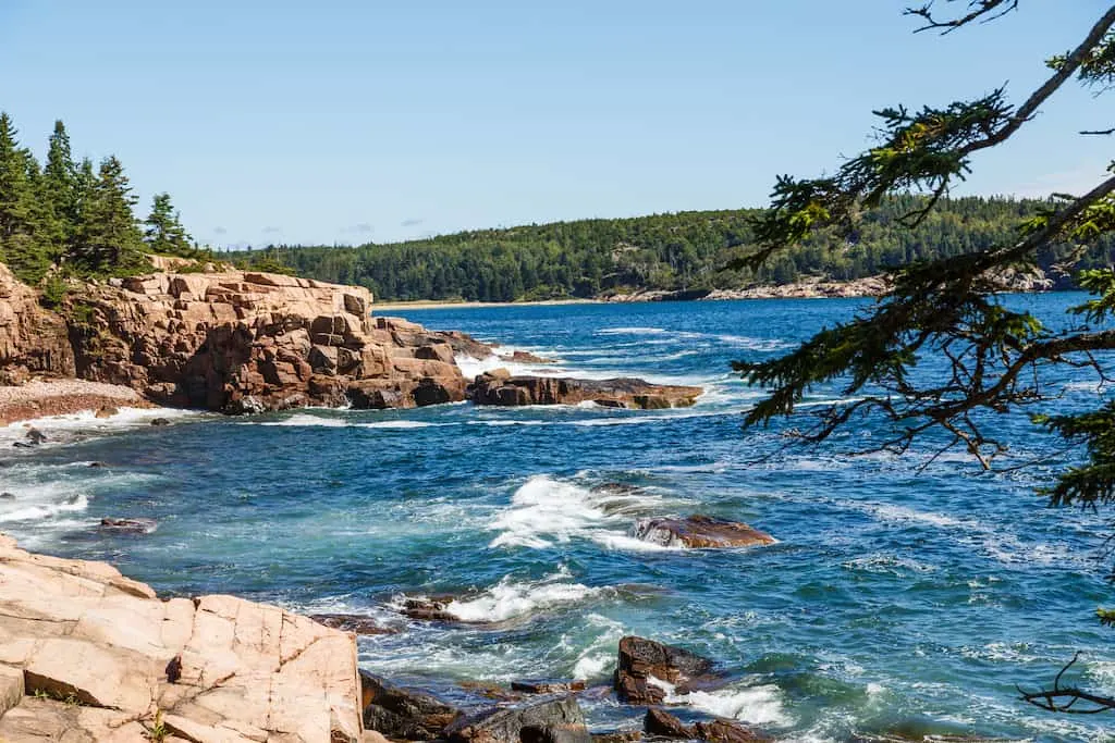 The waves crashing on the shore of a rocky coast in Maine.