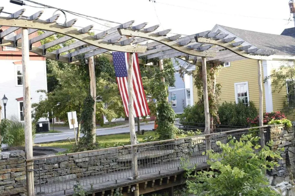 An American flag hanging from a whimsical arbor in Wilmington, VT