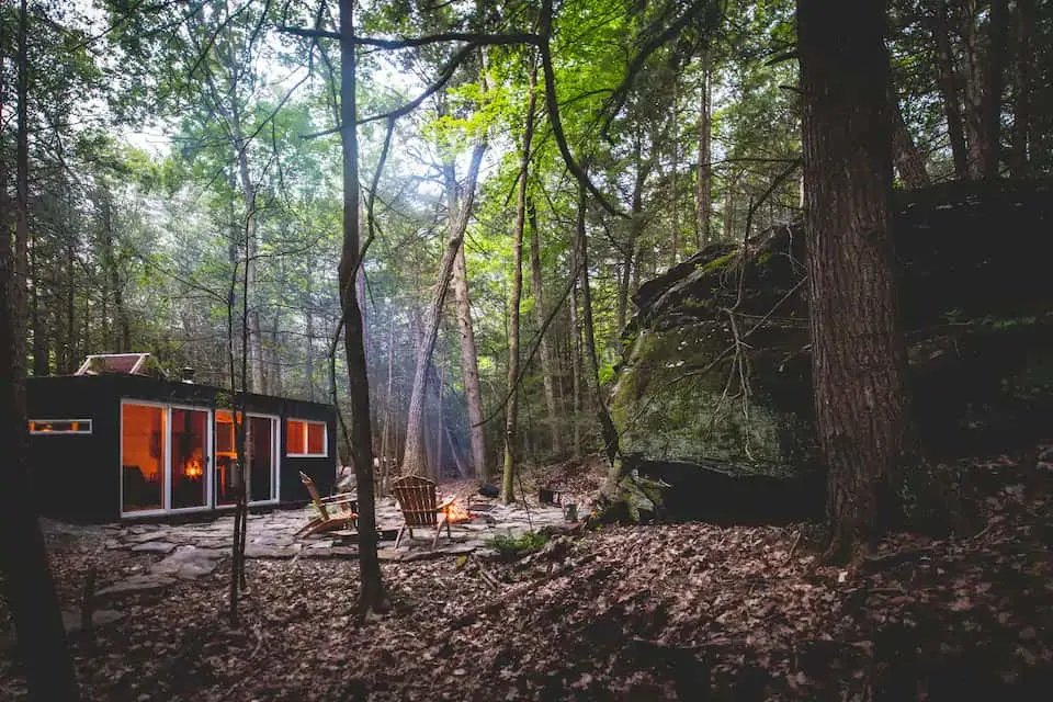 An evening photo of a container cabin in Saugerties, New York. Photo credit: Airbnb