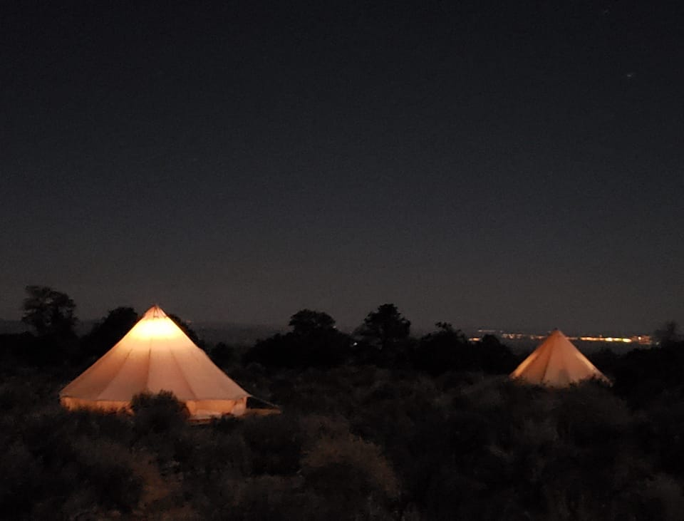 two lit-up glamping tents on the Navajo Nation near the Grand Canyon
