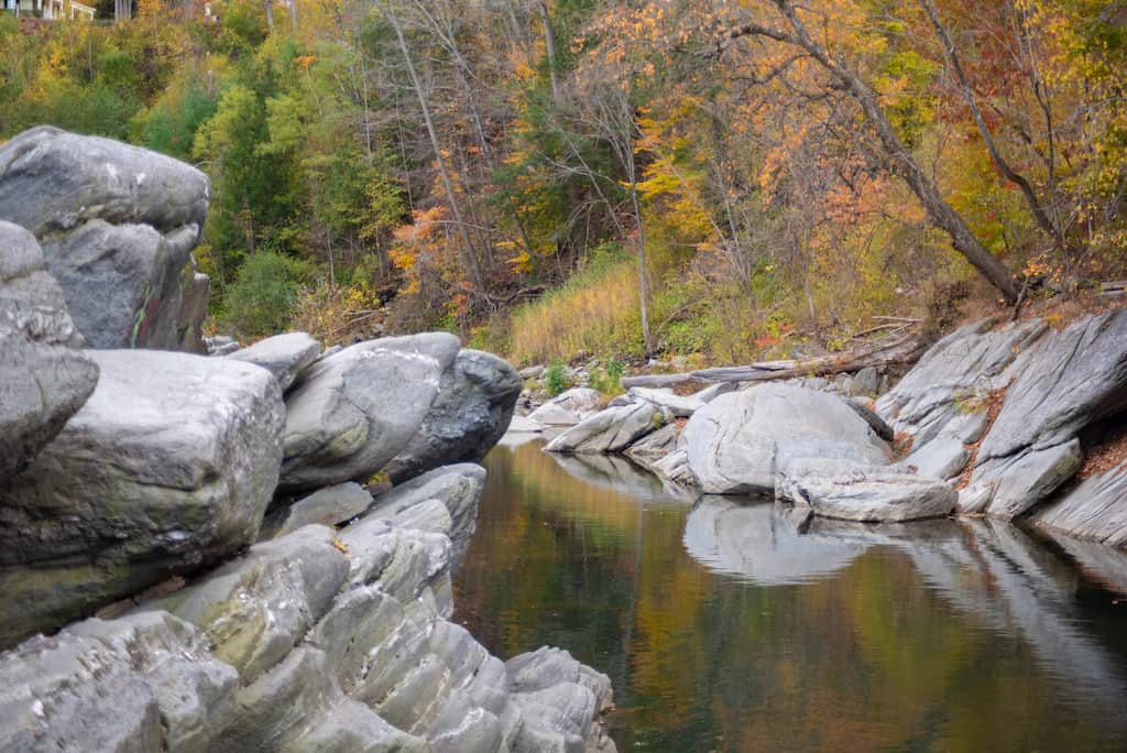 Autum foliage reflected in. the Ottauquechee River at Quechee Gorge