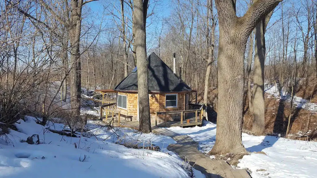 A glamping cabin in Ovid, NY covered with snow. Photo credit: Airbnb