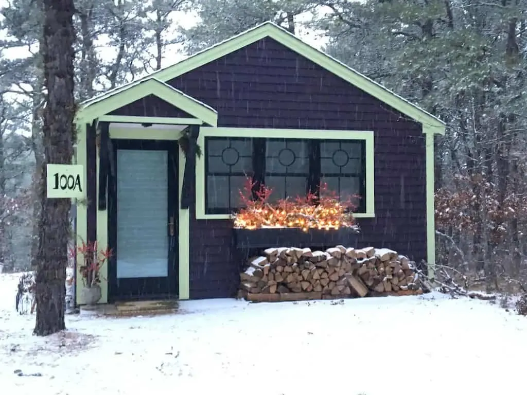 A small glamping cottage for rent in Wellfleet,MA. The cottage is in the woods and surrounded by snow. Photo credit: Airbnb