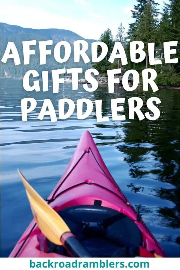 The front of a kayak looking toward a mountain lake. Caption reads: Affordable gifts for paddlers