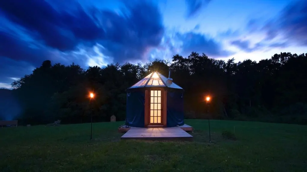 A yurt glows bright at night in New York. Photo source: Airbnb