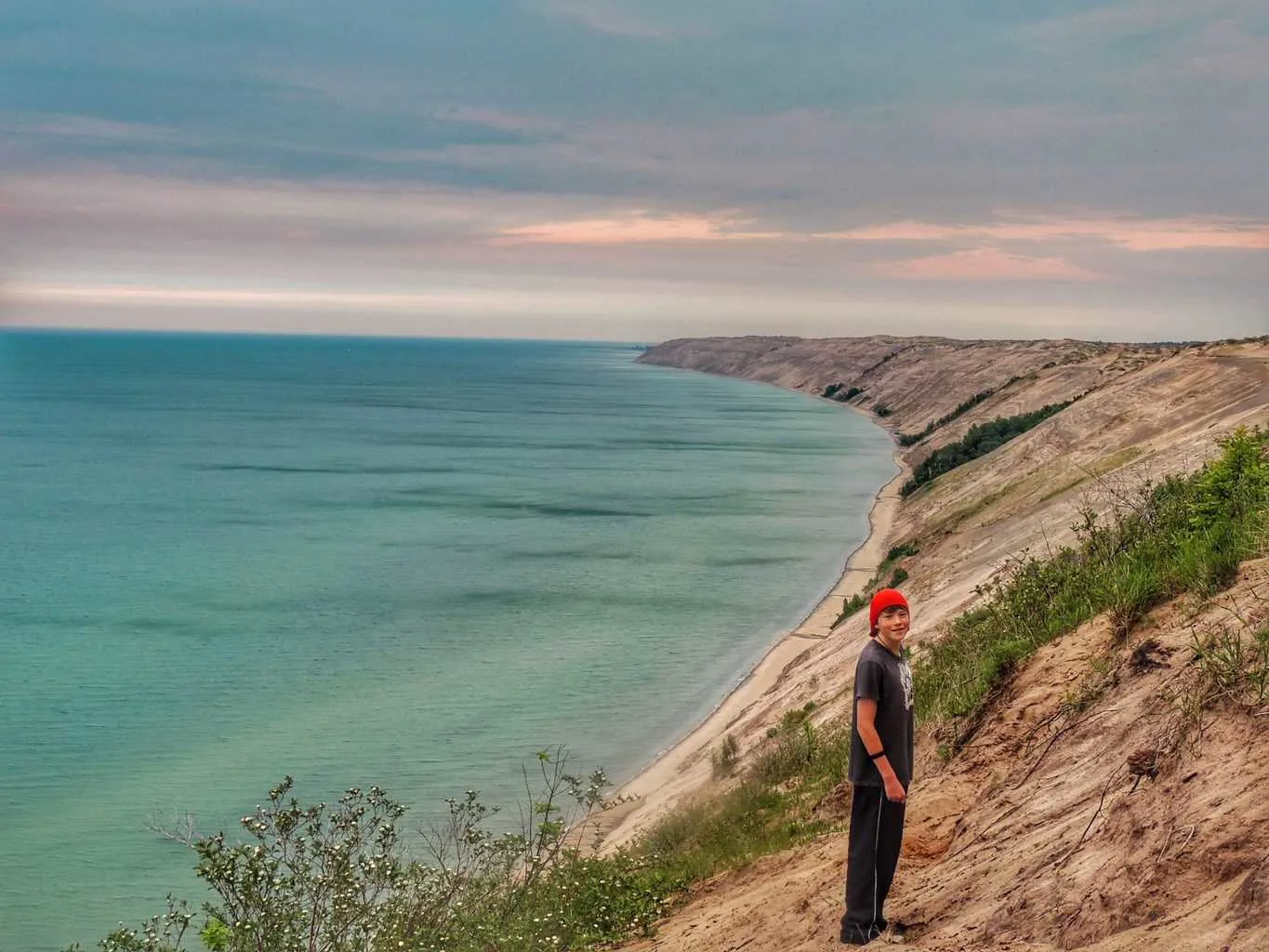 Rowan standing on a dune at the edge of Lake Superior at Pictured Rocks National Lakeshore in Michigan.