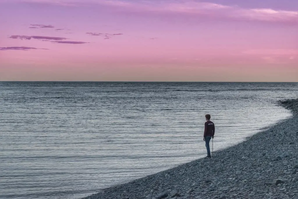 Gabe watching the sunset over the Bay of Fundy in New Brunswick, Canada